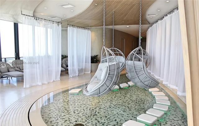 swimming pool view with a floor to ceiling window and couch