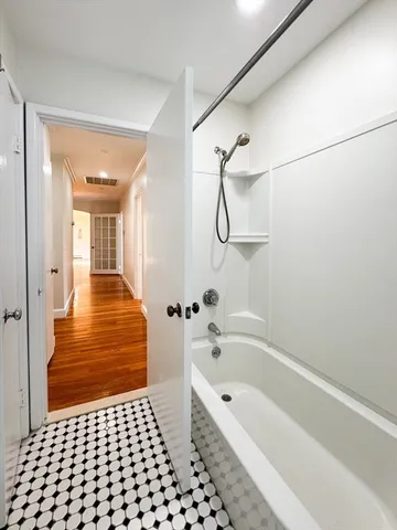 a bathroom with a bathtub and shower