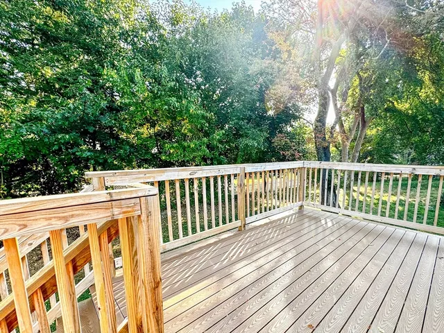 a balcony with wooden floor and fence