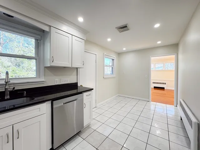 a kitchen with granite countertop a sink and a stove top oven