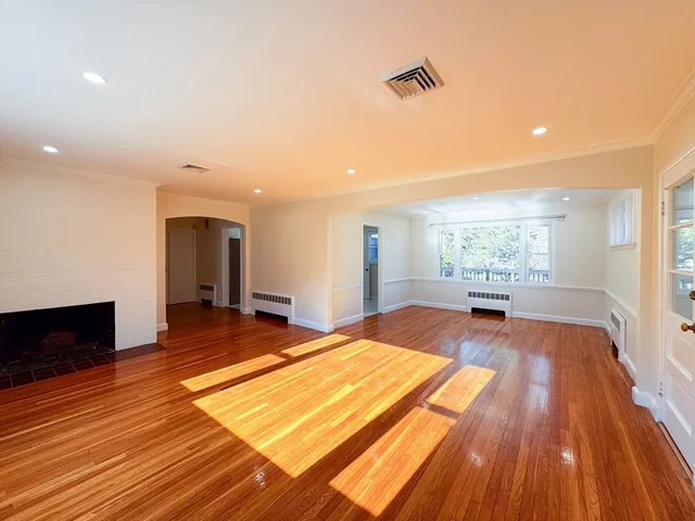 a spacious bedroom with a bed and a flat screen tv