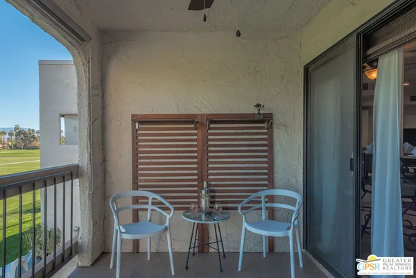 a view of a room with chairs and windows