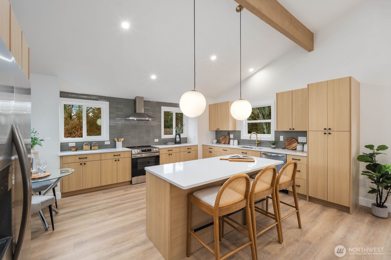 2525 178th Street Southeast Bothell, WA 98012 - Photo 11 of 39 a kitchen with a dining table cabinets and stainless steel appliances