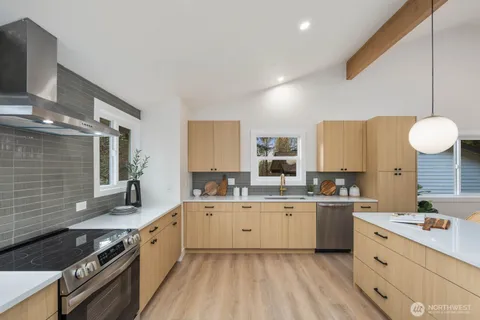a kitchen with a sink stove and cabinets