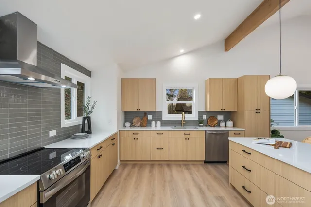 a kitchen with a sink stove and cabinets