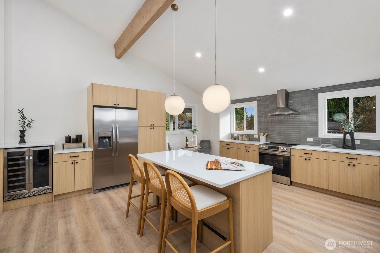 2525 178th Street Southeast Bothell, WA 98012 - Photo 15 of 39 a kitchen with stainless steel appliances a stove a sink a kitchen island with chairs and wooden floor