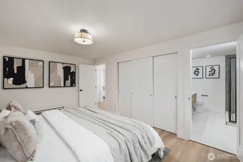 a bedroom with a large bed and a chandelier