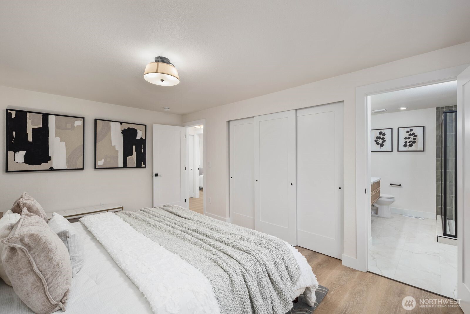 2525 178th Street Southeast Bothell, WA 98012 - Photo 20 of 39 a bedroom with a large bed and a chandelier