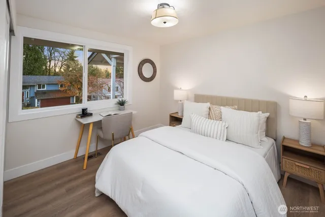 a bedroom with a bed and a table