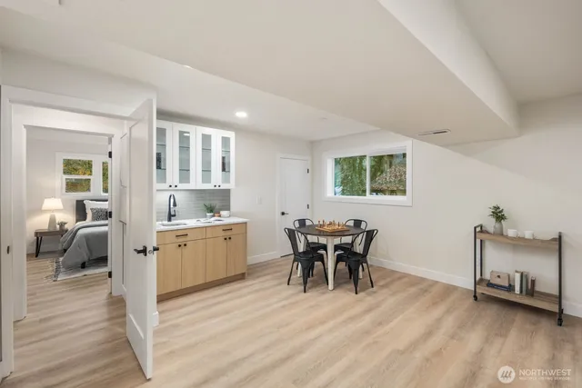 a dining room with furniture and wooden floor
