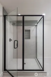 a bathroom with a glass shower door
