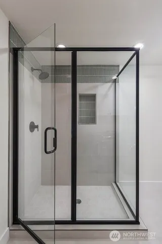 a bathroom with a glass shower door