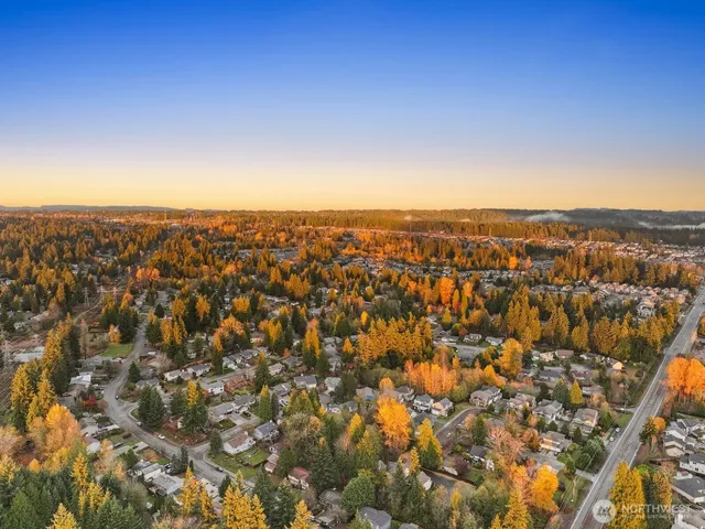 an aerial view of residential houses with city view