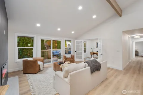 a living room with furniture and large window