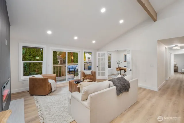 a living room with furniture and large window