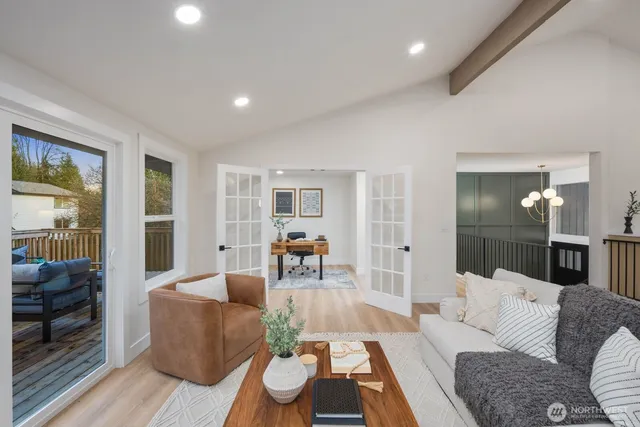 a living room with furniture and wooden floor