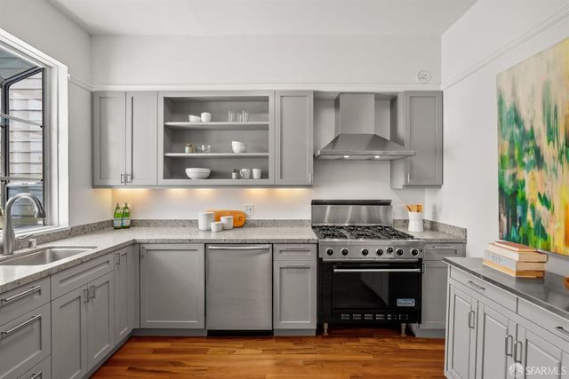 a kitchen with a stove cabinets and window