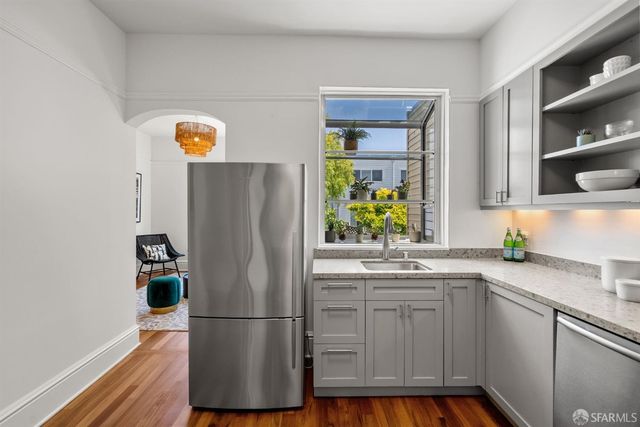 a kitchen with stainless steel appliances granite countertop a refrigerator and a sink