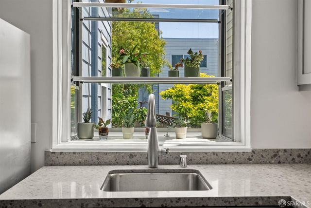 a kitchen with stainless steel appliances granite countertop a stove and wooden floor