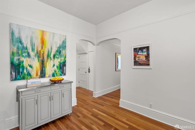 a view of a dining room with furniture and wooden floor