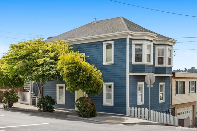a front view of a house with trees