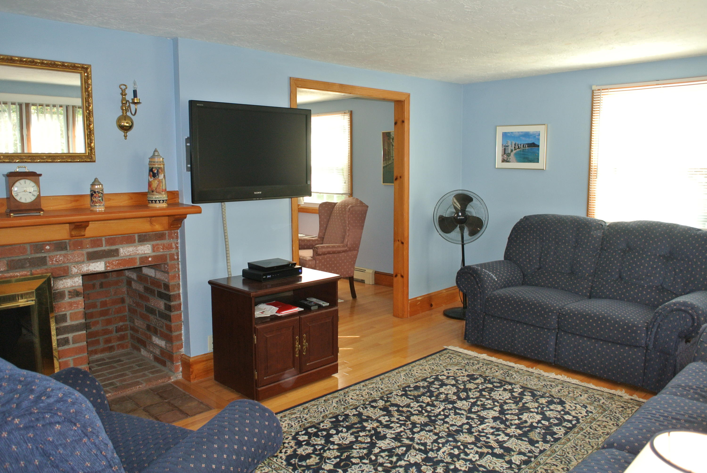 4 Alma Road Mashpee, MA 02649 - Photo 14 of 19 a living room with furniture a flat screen tv and a fireplace
