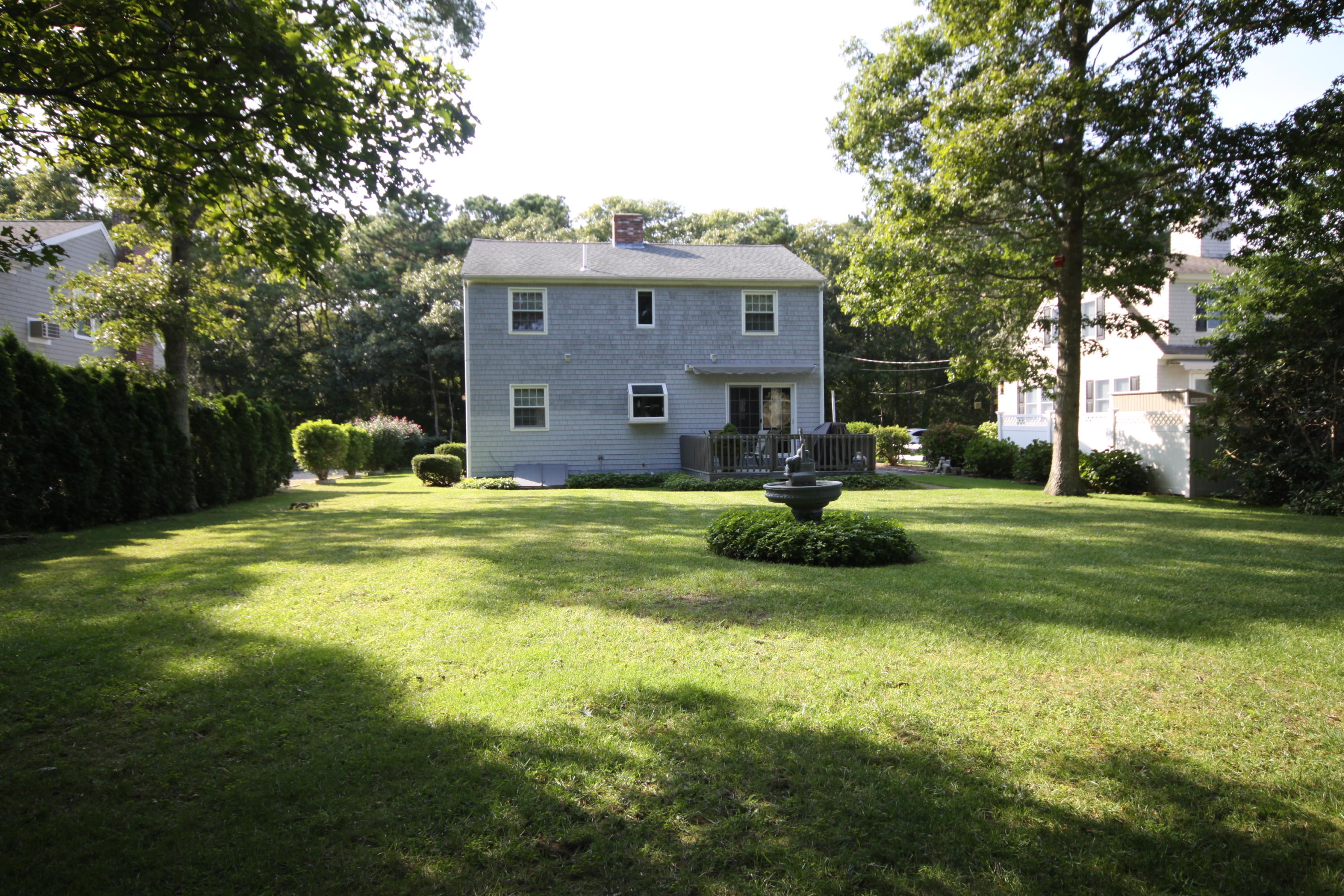 4 Alma Road Mashpee, MA 02649 - Photo 4 of 19 a front view of a house with garden and trees