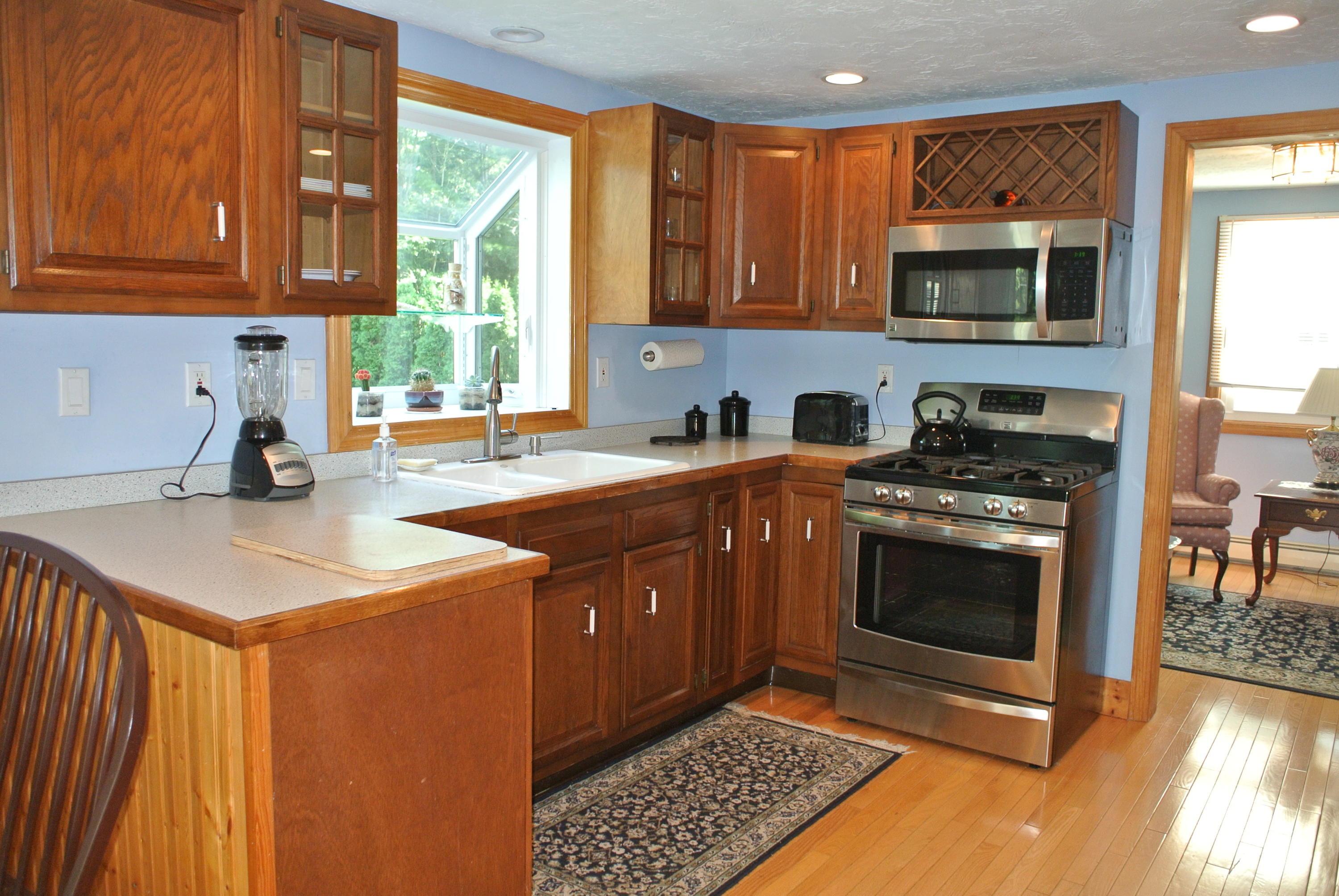 4 Alma Road Mashpee, MA 02649 - Photo 10 of 19 a kitchen with stainless steel appliances a stove a sink and a microwave