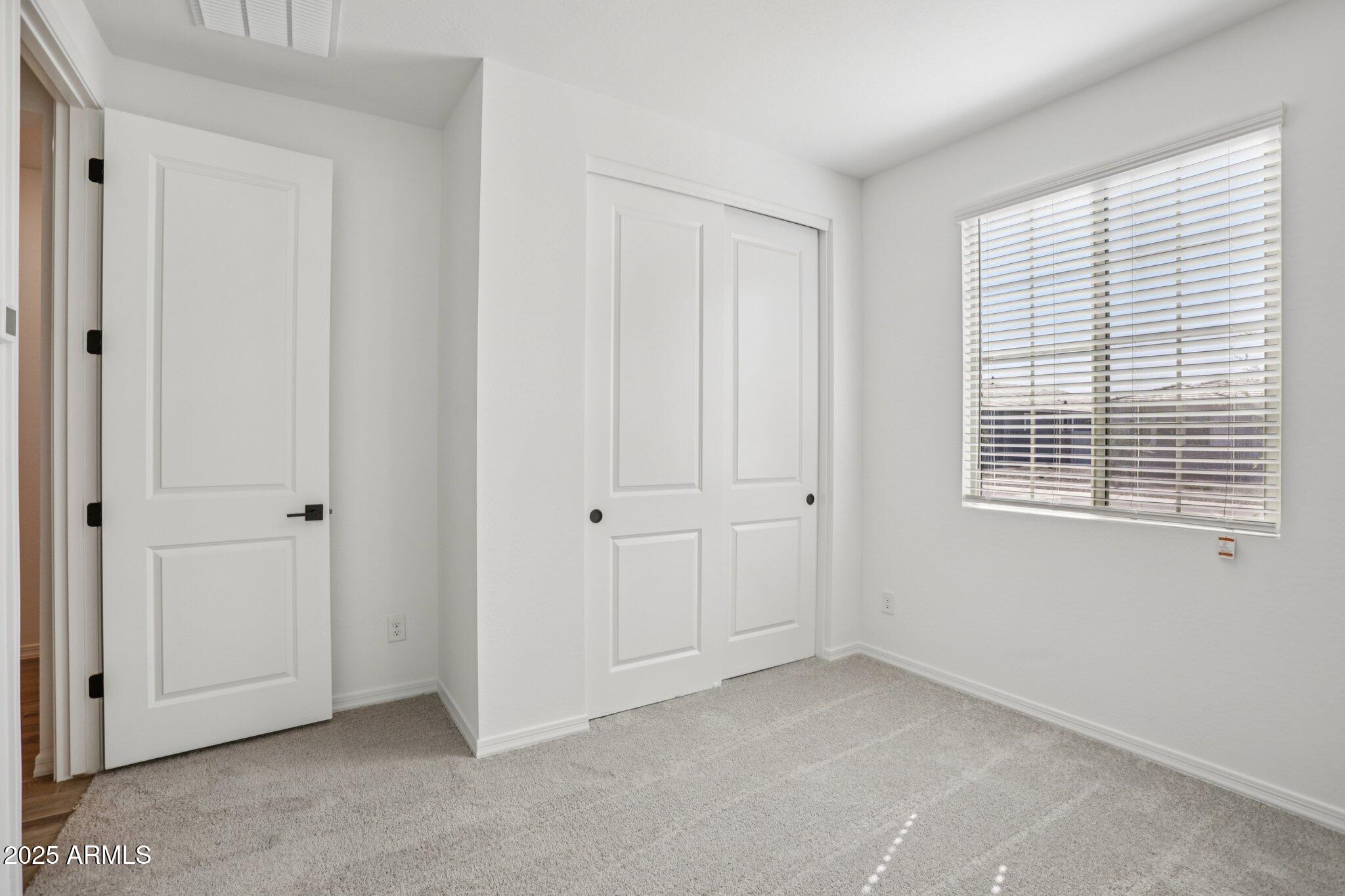 5528 West Hopi Trail Laveen, AZ 85339 - Photo 15 of 51 a view of an empty room with windows