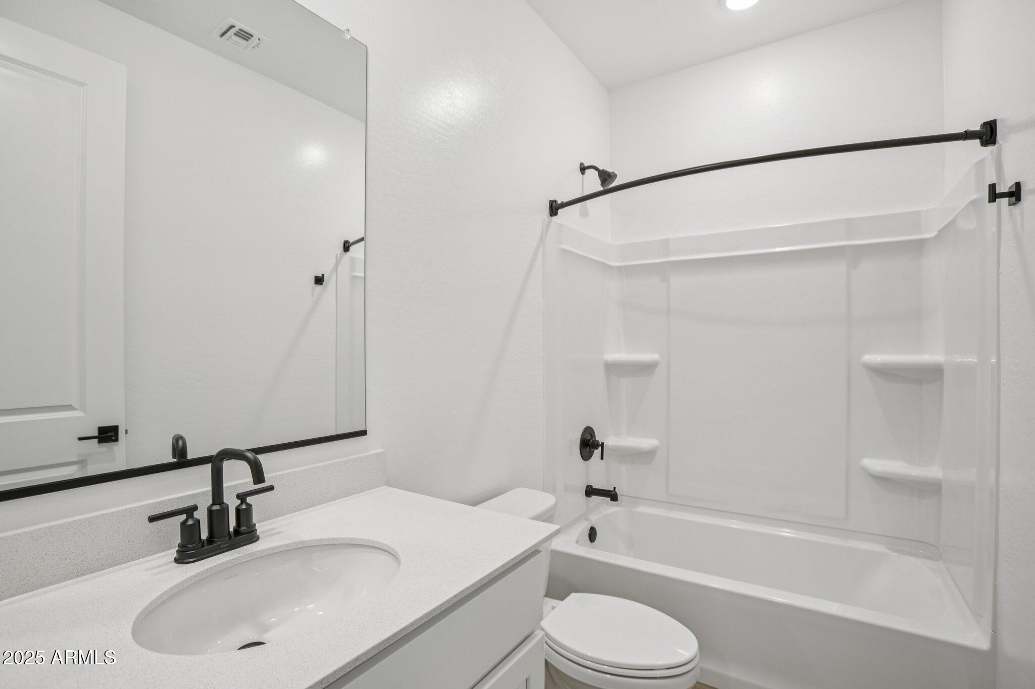 5528 West Hopi Trail Laveen, AZ 85339 - Photo 16 of 51 a bathroom with a sink toilet and shower