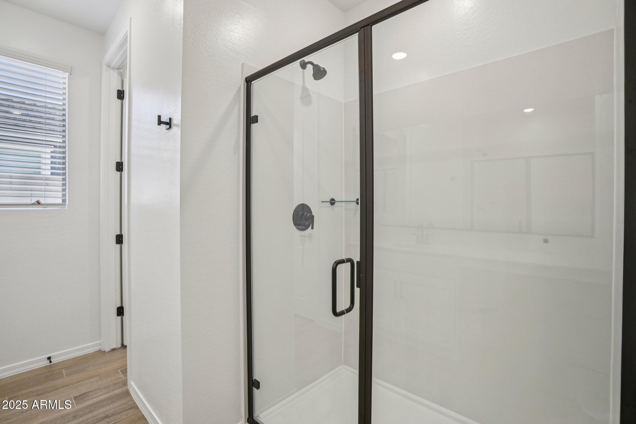 5528 West Hopi Trail Laveen, AZ 85339 - Photo 28 of 51 a bathroom with a shower and a glass door