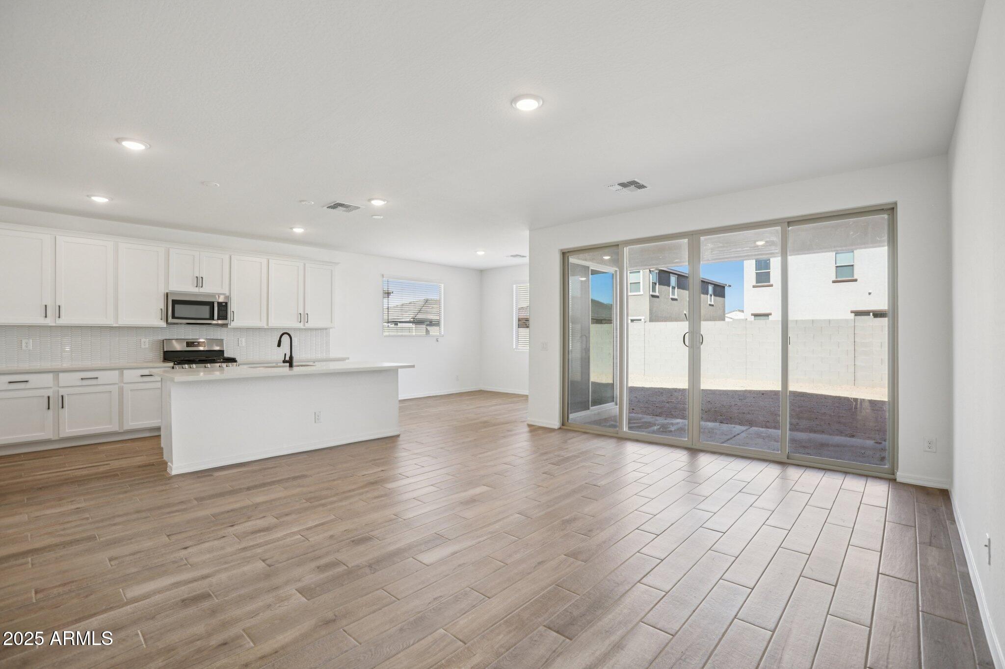 5528 West Hopi Trail Laveen, AZ 85339 - Photo 6 of 51 a big room with wooden floor and windows