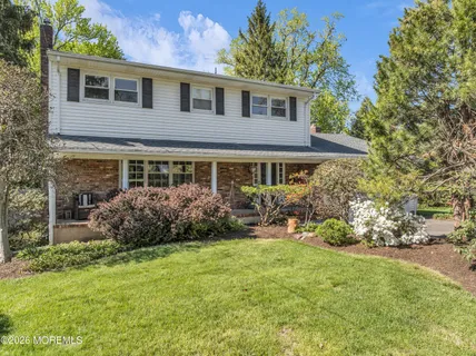 a front view of a house with a yard and porch