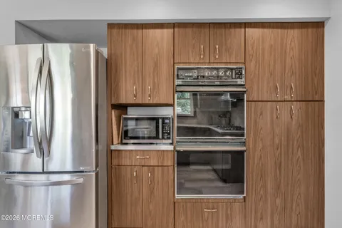 a kitchen with a stove and a refrigerator