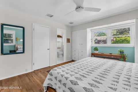 a bedroom with a bed and a painting on the wall