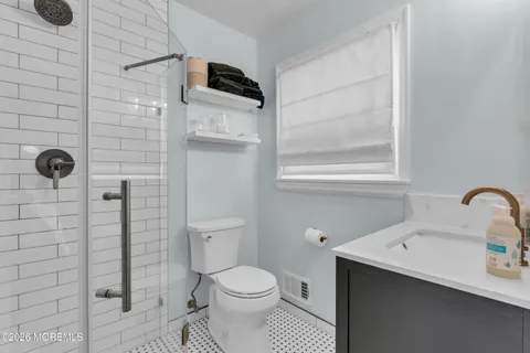a bathroom with a sink toilet and shower