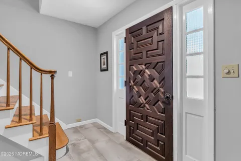 a view of an empty room with a staircase