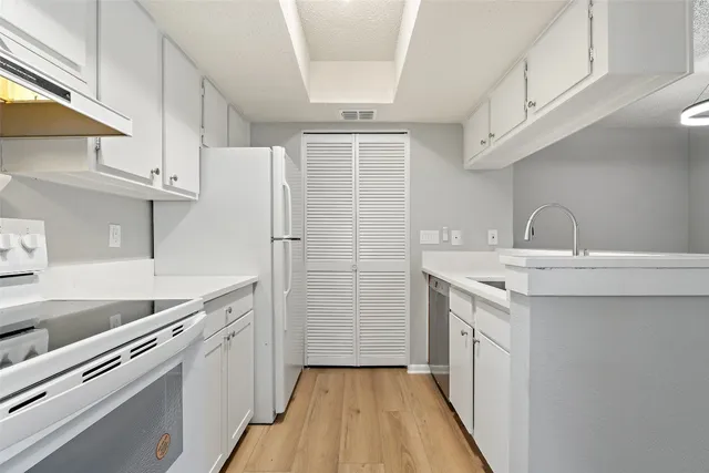 a kitchen with a sink stove and cabinets