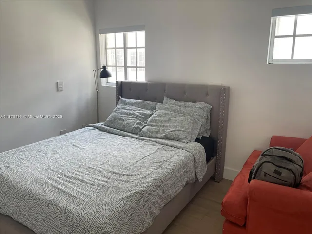 a bedroom with a bed and window