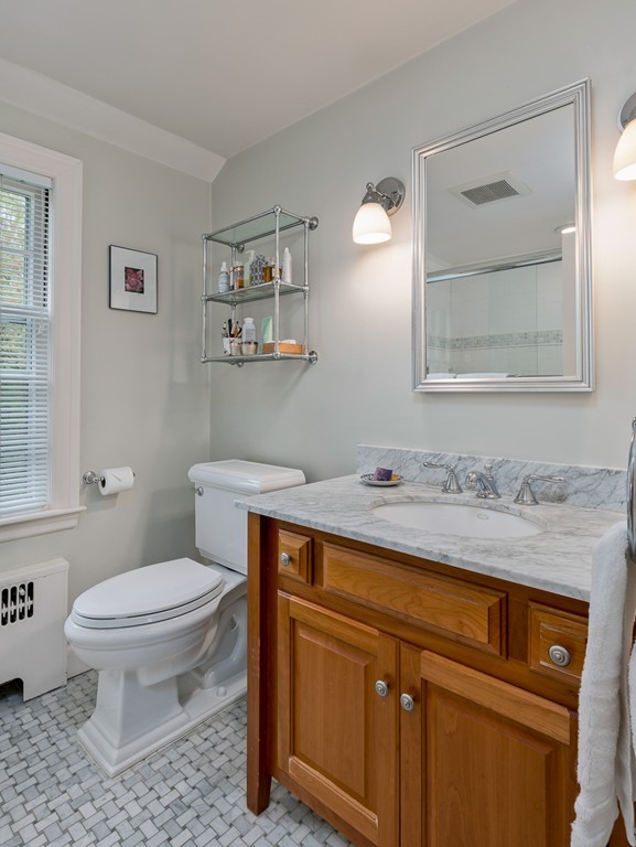 73 Audubon Road Wellesley, MA 02481 - Photo 17 of 24 a bathroom with a granite countertop toilet sink and mirror