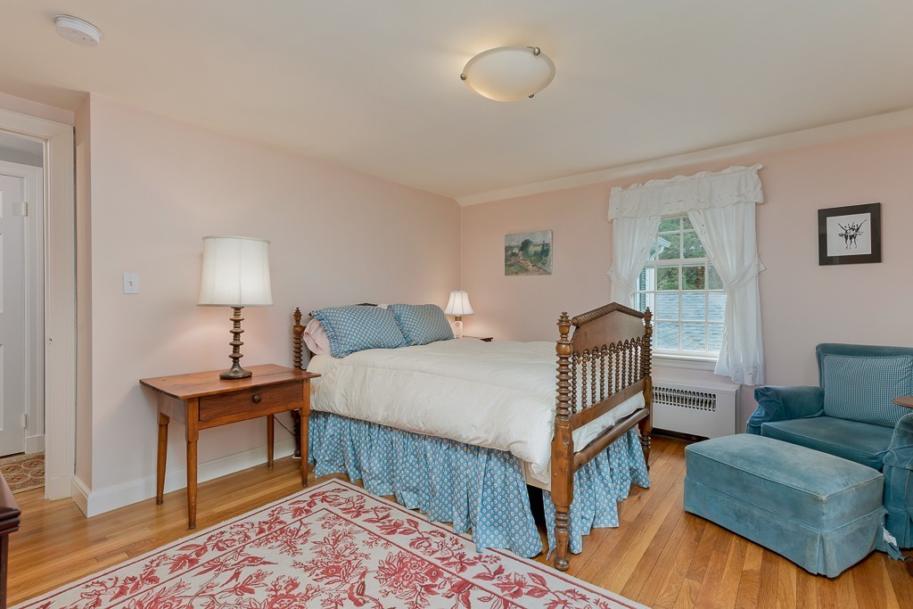73 Audubon Road Wellesley, MA 02481 - Photo 18 of 24 a bedroom with a bed and a couch
