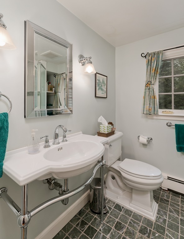73 Audubon Road Wellesley, MA 02481 - Photo 9 of 24 a bathroom with a sink toilet and mirror