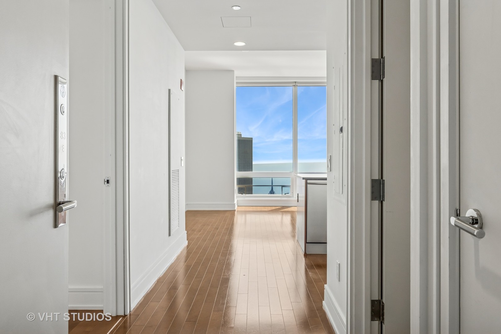 401 North Wabash Avenue, Unit 83E Chicago, IL 60611 - Photo 2 of 33 a view of a hallway with wooden floor and a bathroom