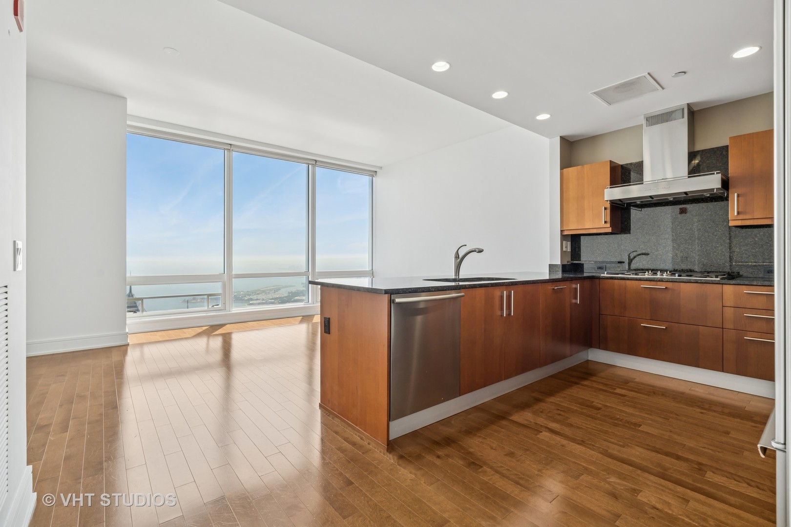 401 North Wabash Avenue, Unit 83E Chicago, IL 60611 - Photo 4 of 33 a kitchen with granite countertop a refrigerator and a sink