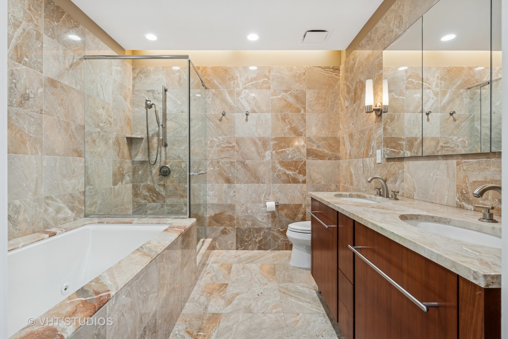 401 North Wabash Avenue, Unit 83E Chicago, IL 60611 - Photo 7 of 33 a bathroom with a granite countertop sink a toilet a mirror and shower