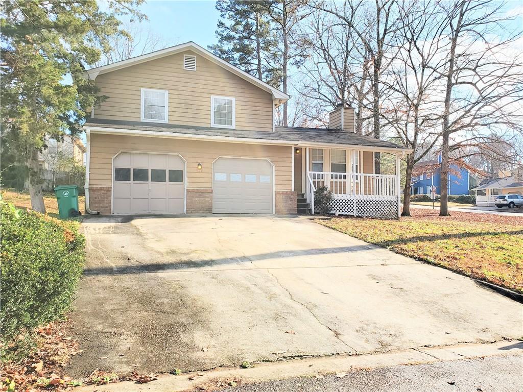 524 Julius Drive Stone Mountain, GA 30087 - Photo 2 of 17 a front view of a house with a yard and trees