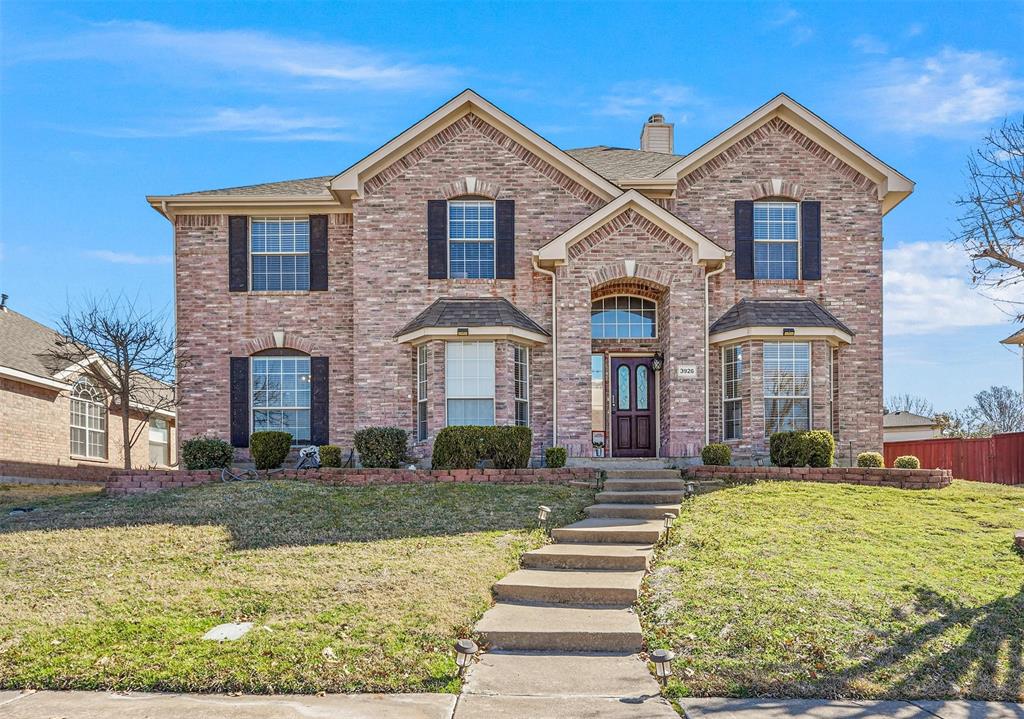 3926 Rolling Oaks Drive Carrollton, TX 75007 - Photo 1 of 21 View of front of home with brick siding, a chimney, a front yard, and fence