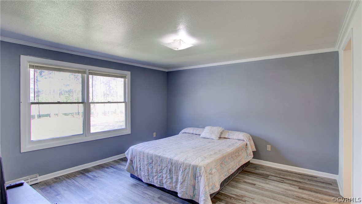 1694 Rolling Acres Road Emporia, VA 23847 - Photo 17 of 45 Bedroom with a textured ceiling, hardwood / wood-s