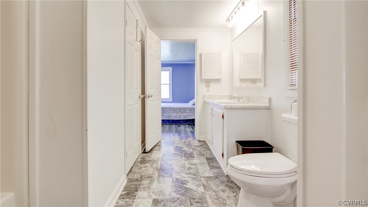 1694 Rolling Acres Road Emporia, VA 23847 - Photo 21 of 45 Bathroom with vanity, crown molding, tile patterne