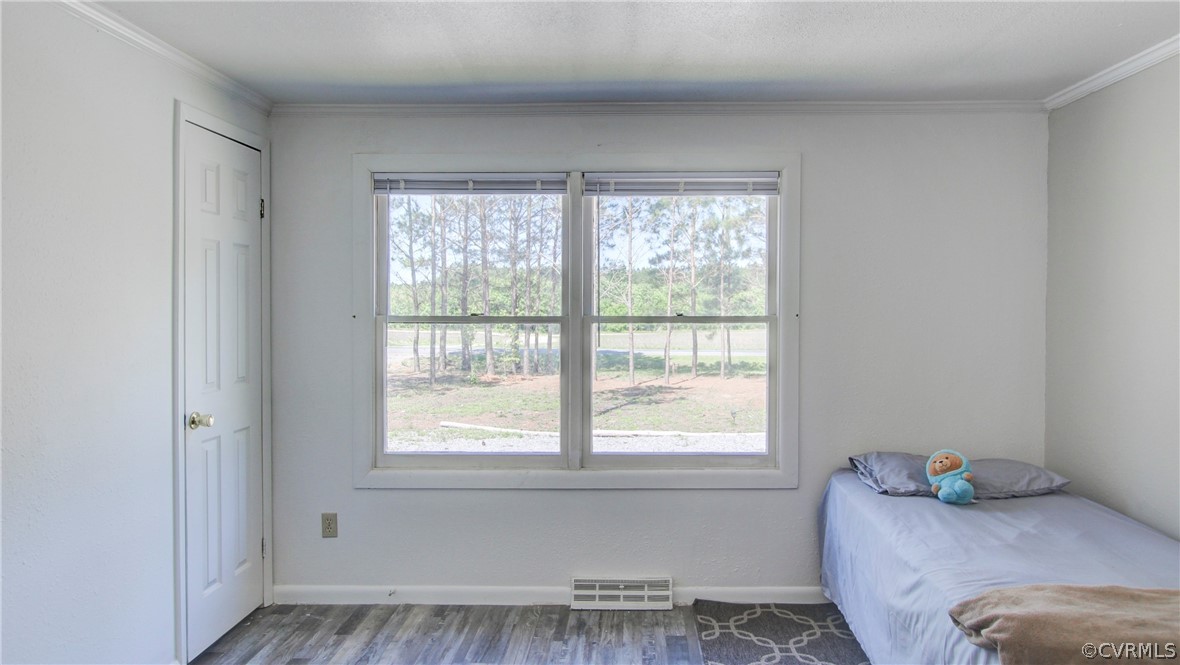 1694 Rolling Acres Road Emporia, VA 23847 - Photo 24 of 45 Bedroom with crown molding and hardwood / wood-sty